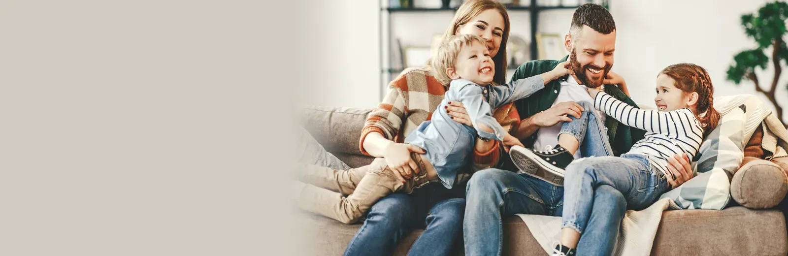 family laughing and playing in living room